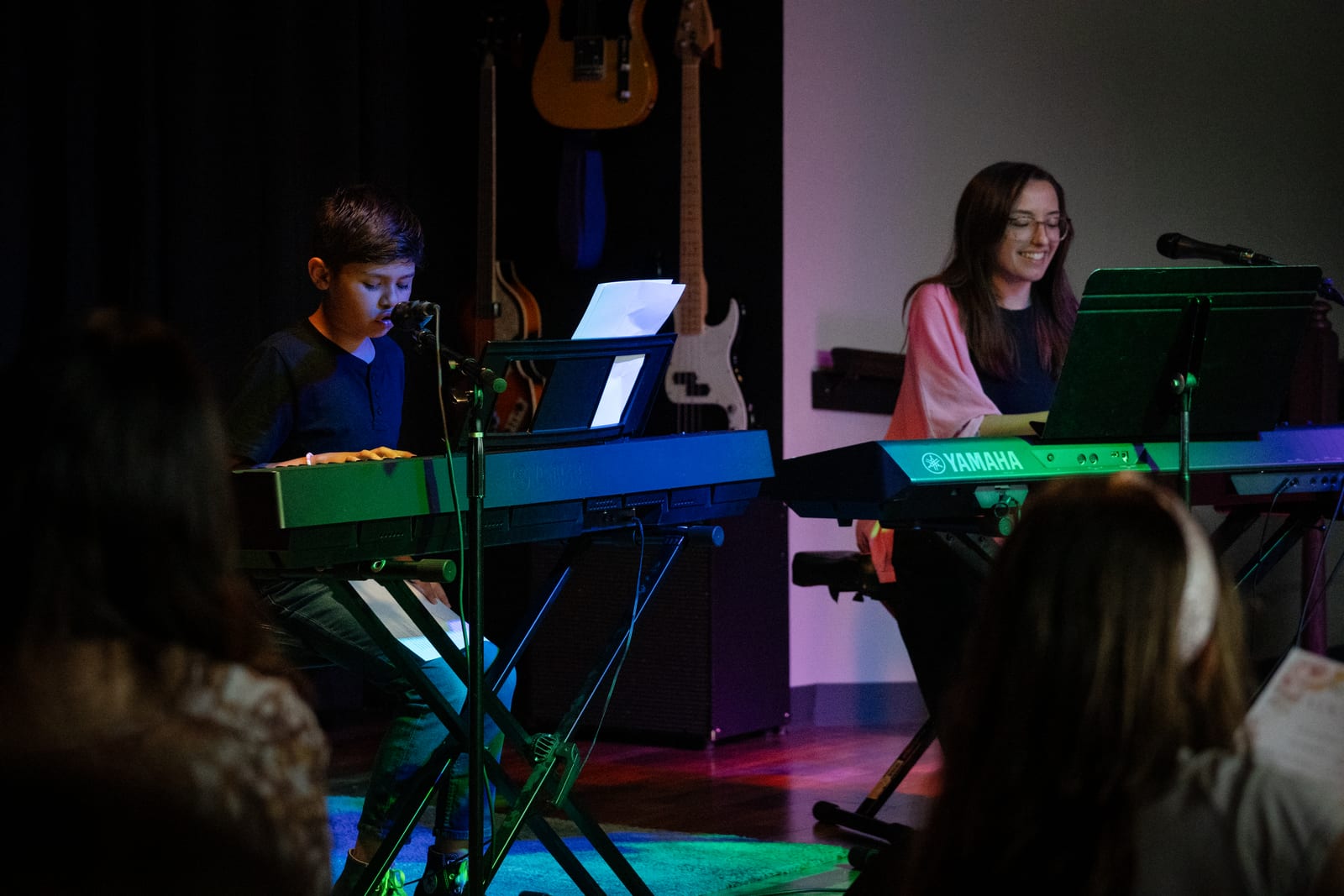 A Twelve Tone vocalist performing solo on stage at the Glenview studio — vulnerability in action.
